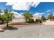 Attractive single-story home featuring desert landscaping, a circular driveway, and an attached two-car garage at 4765 N Grand Canyon Dr, Las Vegas, NV 89129