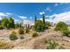 This house features a xeriscaped yard, mature trees, and a unique architectural design at 4765 N Grand Canyon Dr, Las Vegas, NV 89129