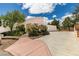 Contemporary home with well-manicured landscaping, a circular driveway, and an attached garage at 4765 N Grand Canyon Dr, Las Vegas, NV 89129