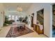 Elegant foyer with tile floors, a staircase, chandelier lighting, and a view into the living spaces at 4765 N Grand Canyon Dr, Las Vegas, NV 89129