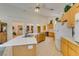 Spacious kitchen featuring wooden cabinets, tile flooring, a curved island, and modern appliances at 4765 N Grand Canyon Dr, Las Vegas, NV 89129
