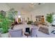 Bright, open living room with ample seating, large windows, and views to the foyer at 4765 N Grand Canyon Dr, Las Vegas, NV 89129