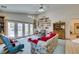Living room with a ceiling fan, backyard access, and comfortable furniture at 4765 N Grand Canyon Dr, Las Vegas, NV 89129