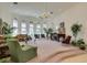 Inviting living room featuring a baby grand piano, large windows, and high ceilings at 4765 N Grand Canyon Dr, Las Vegas, NV 89129