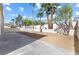 Spacious backyard featuring desert landscaping, tall palm trees and a block fence at 5035 Meadow Grove Ct, Las Vegas, NV 89120