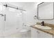 Bathroom with a shower-tub combo, modern vanity, and bright lighting for a refreshing feel at 5035 Meadow Grove Ct, Las Vegas, NV 89120