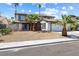 Attractive two-story home with a white facade, dark trim, and desert landscaping at 5035 Meadow Grove Ct, Las Vegas, NV 89120