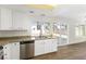 Bright kitchen featuring stainless steel appliances, granite countertops, and sliding glass doors to backyard at 5035 Meadow Grove Ct, Las Vegas, NV 89120