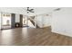 Bright and airy living room featuring a fireplace, modern ceiling fan, and wood-look floors at 5035 Meadow Grove Ct, Las Vegas, NV 89120