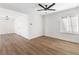 Bright living room featuring new floors, a modern ceiling fan, and natural light from a large window at 5035 Meadow Grove Ct, Las Vegas, NV 89120