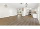 Spacious room showcasing new floors, modern lighting, and an open connection to the kitchen at 5035 Meadow Grove Ct, Las Vegas, NV 89120