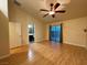 Large bedroom featuring modern lighting, hard floors, and access to backyard and bathroom at 5512 Oakwood Ridge St, Las Vegas, NV 89130