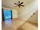 Bedroom with sliding door to backyard, ceiling fan, hard flooring, and modern sconces at 5512 Oakwood Ridge St, Las Vegas, NV 89130
