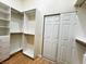 Custom walk-in closet features ample space, open shelving and double sliding door at 5512 Oakwood Ridge St, Las Vegas, NV 89130