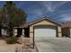 Charming single-story home featuring a two-car garage and low-maintenance desert landscaping at 5512 Oakwood Ridge St, Las Vegas, NV 89130