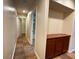 Clean hallway featuring built-in cabinets, leading to the bathroom and bedrooms at 5512 Oakwood Ridge St, Las Vegas, NV 89130