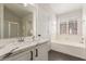 Stylish bathroom featuring a soaking tub, and vanity with marble countertop at 5588 La Sendas Ct, Las Vegas, NV 89122
