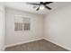 Bedroom featuring ceiling fan and a bright window with carpeted floors at 5588 La Sendas Ct, Las Vegas, NV 89122