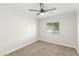 Neutral bedroom with carpet, a ceiling fan, and a bright window at 5588 La Sendas Ct, Las Vegas, NV 89122