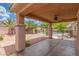 Relaxing covered patio with ceiling fan overlooks the fenced pool area with desert landscaping and privacy at 5588 La Sendas Ct, Las Vegas, NV 89122