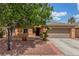 Charming single-story home featuring a well-maintained yard, mature tree, and a two-car garage at 5588 La Sendas Ct, Las Vegas, NV 89122