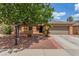 Charming single-story home featuring a well-maintained yard, mature tree, and a two-car garage at 5588 La Sendas Ct, Las Vegas, NV 89122