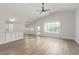 Bright, open-concept living space featuring wood-look flooring, high ceilings, and a view into the kitchen at 5588 La Sendas Ct, Las Vegas, NV 89122