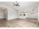 Bright, open-concept living space featuring wood-look flooring, high ceilings, and views of kitchen and dining areas at 5588 La Sendas Ct, Las Vegas, NV 89122