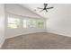 Spacious main bedroom features plush carpet, a ceiling fan, and plenty of natural light at 5588 La Sendas Ct, Las Vegas, NV 89122