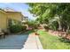 Backyard featuring lush lawn, mature trees, a patio and brick-lined flower beds at 5844 Gushing Spring Ave, Las Vegas, NV 89131