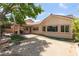 Exterior view of a backyard with landscaping and outdoor kitchen and a covered patio at 5844 Gushing Spring Ave, Las Vegas, NV 89131
