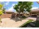 Landscaped backyard featuring artificial grass and a built-in outdoor kitchen at 5844 Gushing Spring Ave, Las Vegas, NV 89131