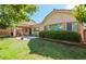 This backyard features a covered patio, well-maintained lawn, and mature landscaping that offers privacy and curb appeal at 5844 Gushing Spring Ave, Las Vegas, NV 89131