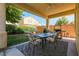 Backyard patio with table, chairs, grill, and block wall at 5844 Gushing Spring Ave, Las Vegas, NV 89131