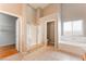 Large bathroom with separate shower and tub, tile floors, and access to the walk-in closet and separate toilet at 5844 Gushing Spring Ave, Las Vegas, NV 89131