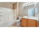 A clean bathroom featuring a shower over tub, vanity and tile flooring at 5844 Gushing Spring Ave, Las Vegas, NV 89131
