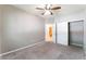 Bedroom with carpet, ceiling fan, and access to closet and bathroom at 5844 Gushing Spring Ave, Las Vegas, NV 89131