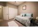Neutral-toned bedroom with soft carpet, queen bed and a double door closet at 5844 Gushing Spring Ave, Las Vegas, NV 89131