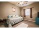 Cozy bedroom with ceiling fan, a bed with decorative pillows, and side tables at 5844 Gushing Spring Ave, Las Vegas, NV 89131