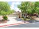 Charming single-story home with a two-car garage, For Sale sign and mature landscaping at 5844 Gushing Spring Ave, Las Vegas, NV 89131