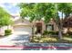 Charming single-story home with a two-car garage, For Sale sign and mature landscaping at 5844 Gushing Spring Ave, Las Vegas, NV 89131