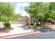 Charming single-story home with a two-car garage, For Sale sign and mature landscaping at 5844 Gushing Spring Ave, Las Vegas, NV 89131