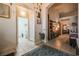 Hallway with archways leading to laundry room; neutral decor with tiled flooring at 5844 Gushing Spring Ave, Las Vegas, NV 89131