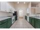 Galley-style kitchen features tile flooring, stainless refrigerator, and ample countertop space at 5844 Gushing Spring Ave, Las Vegas, NV 89131