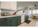 Bright kitchen featuring dark green lower cabinets and white upper cabinets at 5844 Gushing Spring Ave, Las Vegas, NV 89131