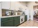 Well-lit kitchen featuring dark green lower cabinets and white upper cabinets at 5844 Gushing Spring Ave, Las Vegas, NV 89131
