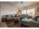 Comfortable living room featuring plantation shutters, neutral colors, and hardwood flooring at 5844 Gushing Spring Ave, Las Vegas, NV 89131