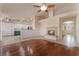 Open-concept living room with hardwood floors, fireplace and combined kitchen at 5844 Gushing Spring Ave, Las Vegas, NV 89131