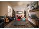 Comfortable living room with a fireplace, warm decor, and ample seating at 5844 Gushing Spring Ave, Las Vegas, NV 89131