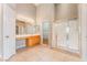 A well-lit main bathroom featuring a vanity, mirror, and walk-in shower at 5844 Gushing Spring Ave, Las Vegas, NV 89131